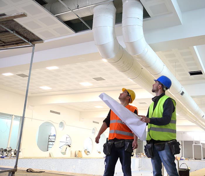 Construction workers reading blueprints