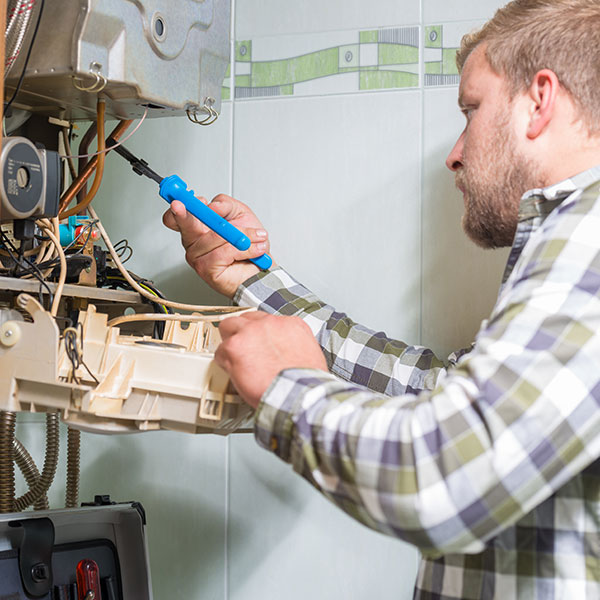 A technician monitoring a furnace reading