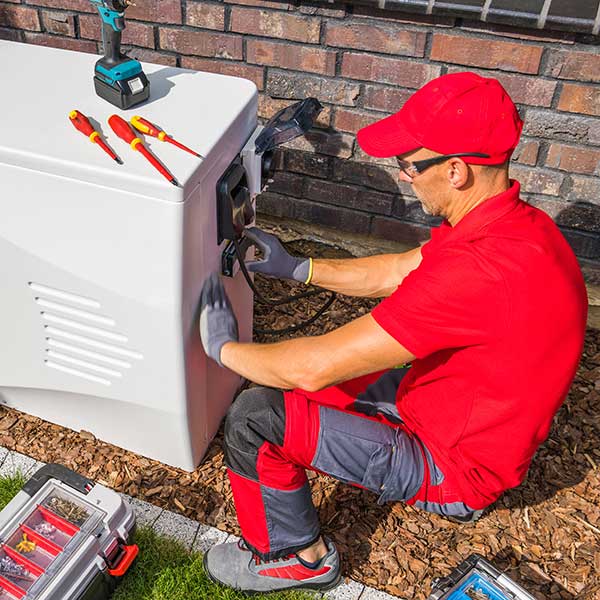 A technician installing a heat pump