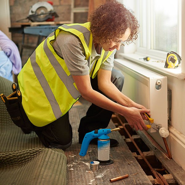 women technician fixing the wall duct