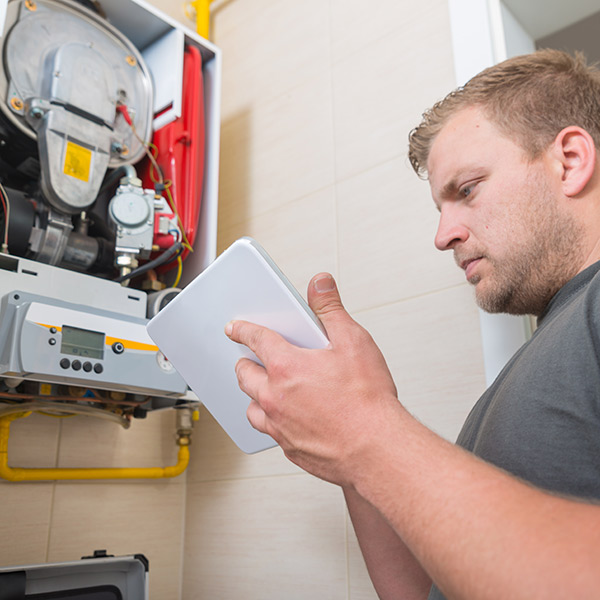 Certified technician conducting regular furnace maintenance in San Joaquin County