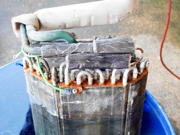 Repairman fixing AC condenser in San Joaquin County