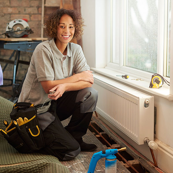 AIR TECH Heating & A/C Service Company technician repairing the wall heater system with tools